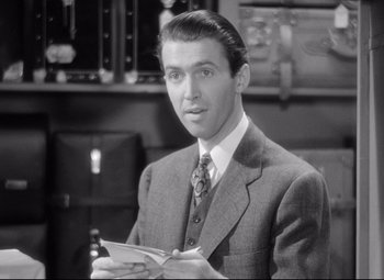 Movie still from “The Shop Around the Corner” (1940), directed by Ernst Lubitsch – A black and white photo of a man in a suit and tie; Close Up shot, High angle