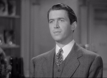 Movie still from “The Shop Around the Corner” (1940), directed by Ernst Lubitsch – A black and white photo of a man in a suit and tie; Close Up shot, Low angle
