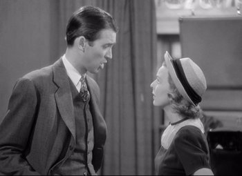 Movie still from “The Shop Around the Corner” (1940), directed by Ernst Lubitsch – A man and a woman standing next to each other; Medium shot, Over the shoulder angle