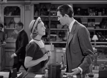 Movie still from “The Shop Around the Corner” (1940), directed by Ernst Lubitsch – A man and a woman talking to each other in a room; Medium shot, Over the shoulder angle