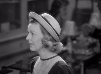Movie still from “The Shop Around the Corner” (1940), directed by Ernst Lubitsch – A young woman wearing a straw hat and a dress; Close Up shot, Over the shoulder angle