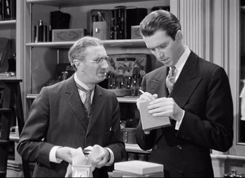 Movie still from “The Shop Around the Corner” (1940), directed by Ernst Lubitsch – Two men in suits are looking at each other; Medium shot, Over the shoulder angle