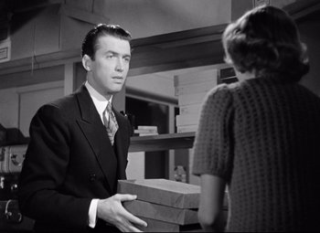 Movie still from “The Shop Around the Corner” (1940), directed by Ernst Lubitsch – A black and white photo of a man and a woman; Medium shot, Over the shoulder angle