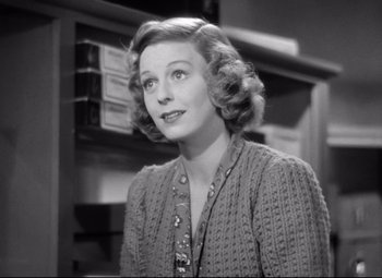 Movie still from “The Shop Around the Corner” (1940), directed by Ernst Lubitsch – An old photo of a woman in a sweater looking to her left; Close Up shot, Low angle