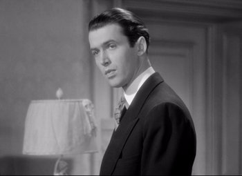 Movie still from “The Shop Around the Corner” (1940), directed by Ernst Lubitsch – A black and white photo of a man in a suit and tie; Close Up shot, Low angle