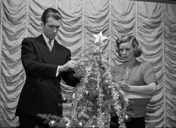 Movie still from “The Shop Around the Corner” (1940), directed by Ernst Lubitsch – A man and a woman decorating a christmas tree; Medium shot, Low angle