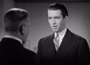 Movie still from “The Shop Around the Corner” (1940), directed by Ernst Lubitsch – A black and white photo of a man in a suit; Close Up shot, Over the shoulder angle