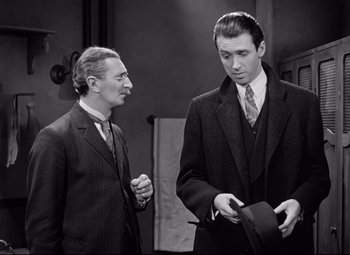 Movie still from “The Shop Around the Corner” (1940), directed by Ernst Lubitsch – Two men standing next to each other wearing suits and ties; Medium shot, Low angle