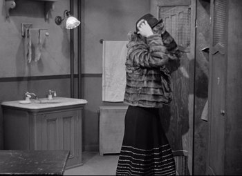 Movie still from “The Shop Around the Corner” (1940), directed by Ernst Lubitsch – A woman standing in front of a bathroom mirror; Medium shot, Over the shoulder angle
