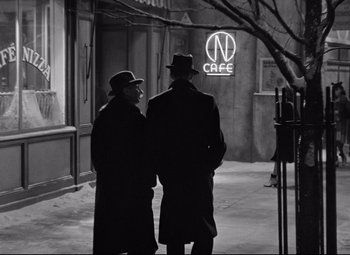 Movie still from “The Shop Around the Corner” (1940), directed by Ernst Lubitsch – A couple of men standing next to each other on a sidewalk; Medium shot, Over the shoulder angle