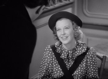 Movie still from “The Shop Around the Corner” (1940), directed by Ernst Lubitsch – An old photo of a woman wearing a polka dot dress; Medium shot, Over the shoulder angle