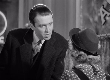 Movie still from “The Shop Around the Corner” (1940), directed by Ernst Lubitsch – A man in a suit talking to a woman in a hat; Close Up shot, Over the shoulder angle