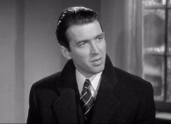 Movie still from “The Shop Around the Corner” (1940), directed by Ernst Lubitsch – A man in a suit and tie looking to his left; Close Up shot, Over the shoulder angle