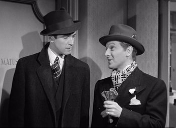 Movie still from “The Shop Around the Corner” (1940), directed by Ernst Lubitsch – Two men in suits and hats standing next to each other; Medium shot, Low angle