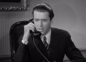 Movie still from “The Shop Around the Corner” (1940), directed by Ernst Lubitsch – A black and white photo of a man talking on a phone; Close Up shot, High angle