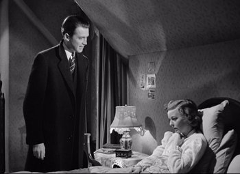 Movie still from “The Shop Around the Corner” (1940), directed by Ernst Lubitsch – A man standing next to a woman sitting in a bed; Medium shot, Low angle