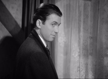 Movie still from “The Shop Around the Corner” (1940), directed by Ernst Lubitsch – A black and white photo of a man in a suit and tie; Close Up shot, High angle