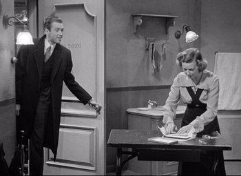 Movie still from “The Shop Around the Corner” (1940), directed by Ernst Lubitsch – A man and a woman are standing in front of a table; Medium shot, Over the shoulder angle