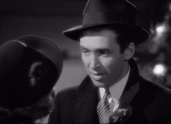 Movie still from “The Shop Around the Corner” (1940), directed by Ernst Lubitsch – A black and white photo of a man wearing a hat; Close Up shot, Over the shoulder angle