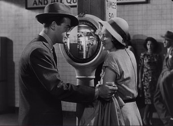 Movie still from “The Snake Pit” (1948), directed by Anatole Litvak – A man and a woman standing in front of a coin meter; Medium shot, Over the shoulder angle