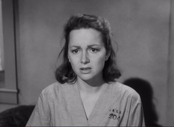 Movie still from “The Snake Pit” (1948), directed by Anatole Litvak – An old photo of a woman in a hospital uniform; Close Up shot, High angle