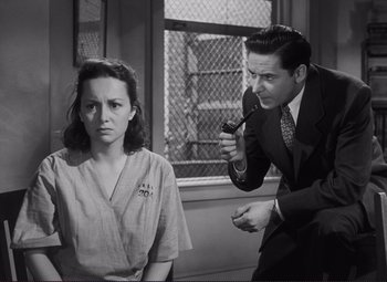 Movie still from “The Snake Pit” (1948), directed by Anatole Litvak – A man and a woman are in a room; Medium shot, High angle
