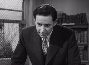 Movie still from “The Snake Pit” (1948), directed by Anatole Litvak – Black and white photograph of a man wearing a suit and tie; Close Up shot, Low angle