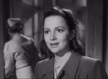 Movie still from “The Snake Pit” (1948), directed by Anatole Litvak – An old photo of a woman in a suit; Close Up shot, Low angle