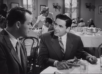 Movie still from “The Snake Pit” (1948), directed by Anatole Litvak – Two men sitting at a table in front of a woman; Medium shot, Over the shoulder angle