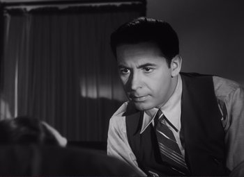Movie still from “The Snake Pit” (1948), directed by Anatole Litvak – Black and white photograph of a man in a suit and tie; Close Up shot, Low angle
