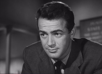 Movie still from “The Snake Pit” (1948), directed by Anatole Litvak – Black and white photograph of a man wearing a suit and tie; Close Up shot, Low angle