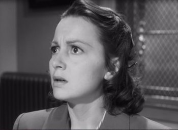 Movie still from “The Snake Pit” (1948), directed by Anatole Litvak – An old photo of a woman looking at the camera; Close Up shot, High angle