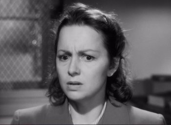 Movie still from “The Snake Pit” (1948), directed by Anatole Litvak – An old photo of a woman looking angry; Close Up shot, High angle