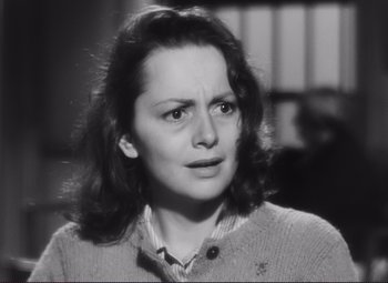 Movie still from “The Snake Pit” (1948), directed by Anatole Litvak – A black - and - white photo of a woman looking at the camera; Close Up shot, Over the shoulder angle