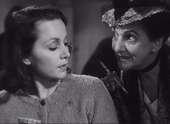 Movie still from “The Snake Pit” (1948), directed by Anatole Litvak – An old photo of a woman and an older woman; Close Up shot, Over the shoulder angle