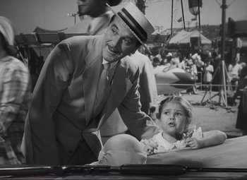 Movie still from “The Snake Pit” (1948), directed by Anatole Litvak – A man and a little girl are sitting in a booth; Medium shot, High angle