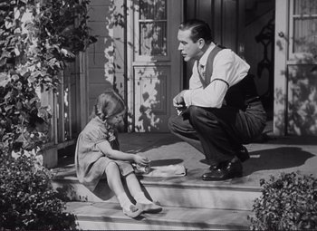 Movie still from “The Snake Pit” (1948), directed by Anatole Litvak – A man and a little girl sitting on the steps; Medium shot, Low angle