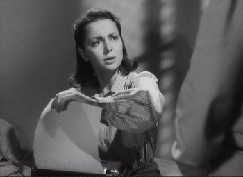 Movie still from “The Snake Pit” (1948), directed by Anatole Litvak – A black - and - white photo of a woman holding a sheet of paper; Close Up shot, High angle