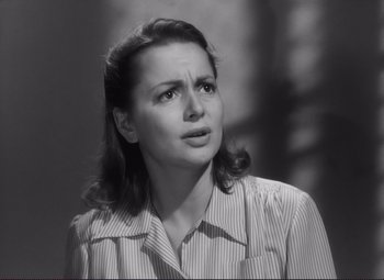 Movie still from “The Snake Pit” (1948), directed by Anatole Litvak – An old photo of a woman in a striped shirt; Close Up shot, High angle