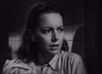 Movie still from “The Snake Pit” (1948), directed by Anatole Litvak – A black - and - white photo of a woman looking sad; Close Up shot, Low angle