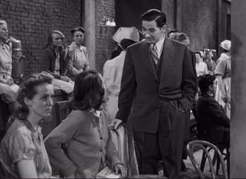 Movie still from “The Snake Pit” (1948), directed by Anatole Litvak – An old photo of a man and two women; Medium shot, Over the shoulder angle