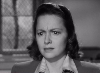 Movie still from “The Snake Pit” (1948), directed by Anatole Litvak – An old black and white photo of a woman looking angry; Close Up shot, High angle