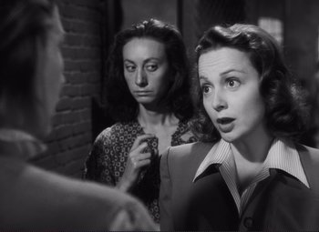 Movie still from “The Snake Pit” (1948), directed by Anatole Litvak – Two women are looking at each other in a room; Close Up shot, Over the shoulder angle