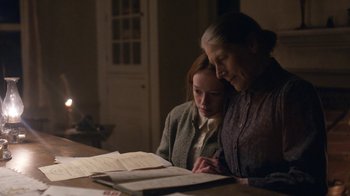 Movie still from “Anne with an E” (2017), created by Moira Walley-Beckett – A woman and a young girl are looking at papers; Medium shot, Over the shoulder angle
