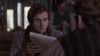 Movie still from “Anne with an E” (2017), created by Moira Walley-Beckett – A man sitting in front of another man holding a newspaper; Close Up shot, Over the shoulder angle