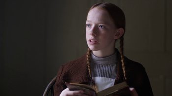 Movie still from “Anne with an E” (2017), created by Moira Walley-Beckett – A young girl is holding a book in her hands; Close Up shot, High angle