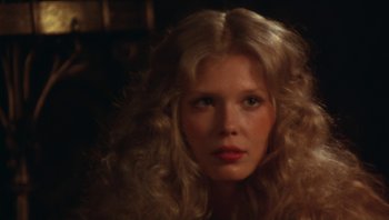 Movie still from “The Song Remains the Same” (1976), directed by Peter Clifton – A person with long blonde hair; Close Up shot, Low angle