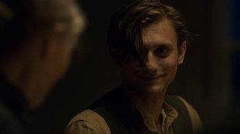 Movie still from “Anne with an E” (2017), created by Moira Walley-Beckett – A man with long brown hair is smiling at the camera; Close Up shot, Over the shoulder angle