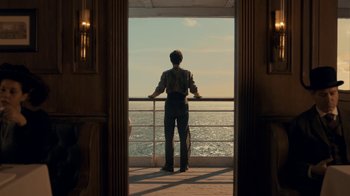Movie still from “Anne with an E” (2017), created by Moira Walley-Beckett – A man standing on a deck looking out at the ocean; Wide shot, Low angle