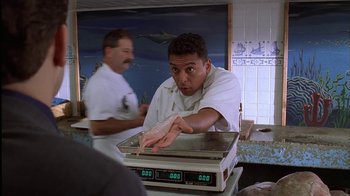 Movie still from “The Sopranos” (1999), created by David Chase – A man in a white shirt is on top of a scale; Medium shot, Low angle